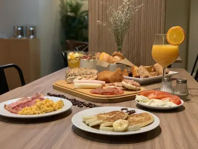 a table topped with plates of food and drinks at Spot Apartments Ceuta in Porto
