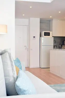 a living room with a couch and a kitchen at Spot Apartments Ceuta in Porto