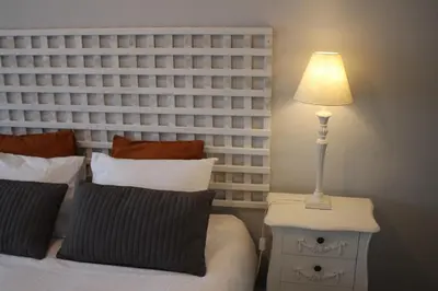 a lamp on a night stand next to a bed at LL Picaria 16 in Porto
