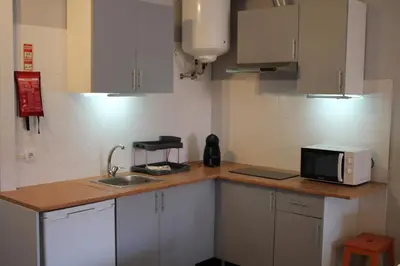 a kitchen with a sink and a microwave on a counter at LL Picaria 16 in Porto