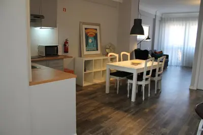 a kitchen and living room with a table and chairs at LL Picaria 16 in Porto