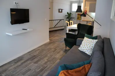 a living room with a couch and a flat screen tv at LL Picaria 16 in Porto