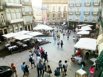 a group of people walking around a street with buildings at Discovery | Porto-Flores in Porto
