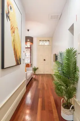 a living room with a parrot painting on the wall at Discovery | Porto-Flores in Porto