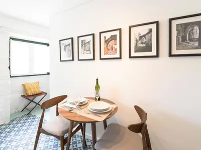 a dining room with a table and chairs at Arco Apartments in Porto
