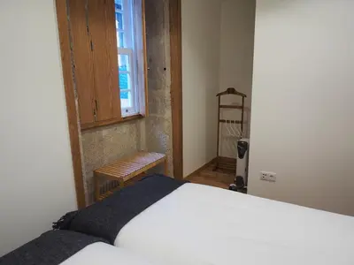 a bedroom with a bed and a window and a ladder at Belomont6 Apartments in Porto