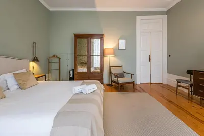 a bedroom with a bed with two towels on it at GuestReady - Picaria Living Quarters in Porto