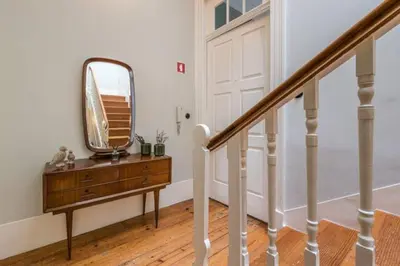 a mirror on top of a dresser in a hallway at GuestReady - Picaria Living Quarters in Porto
