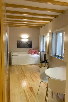 a bedroom with a bed and a table and chairs at Oporto Trendy River in Porto