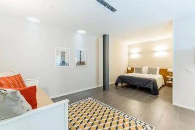 a bedroom with a bed and a couch at Oporto Trendy River in Porto