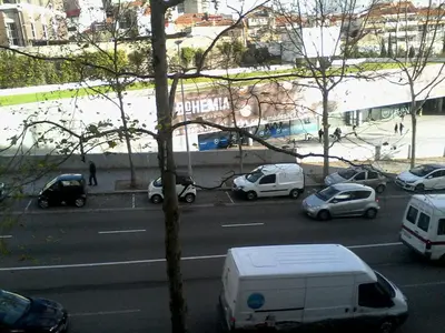 a view of a street with cars parked on the road at Metro-Apartment RNAL nº35375 AL-Chamada para a rede móvel nacional in Porto