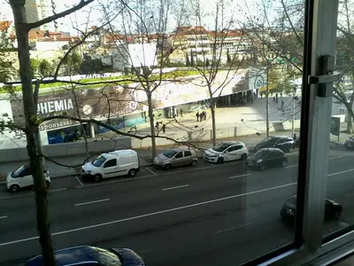 a view from a window of cars parked on a street at Metro-Apartment RNAL nº35375 AL-Chamada para a rede móvel nacional in Porto