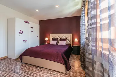a bedroom with a bed with a purple bedspread at Sunrise House in Porto