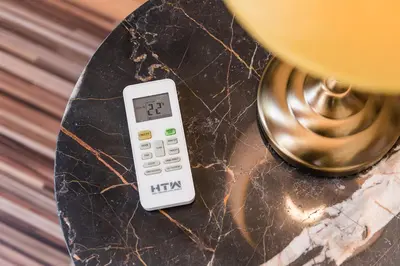 a remote control sitting on a table next to a lamp at Sunrise House in Porto