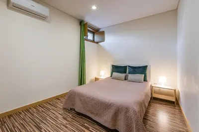 a bedroom with a bed and two night stands at Sunrise House in Porto