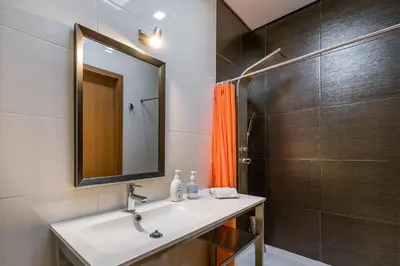 a bathroom with a sink and a shower at Sunrise House in Porto