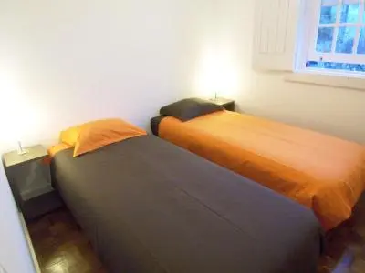 two beds sitting next to each other in a room at Porto Riverside in Porto