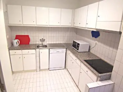 a small kitchen with white cabinets and a microwave at Porto Riverside in Porto