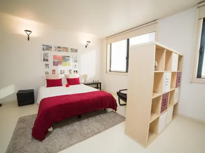 a bedroom with a bed and a book shelf at OPORTO GUEST - Cedofeita in Porto