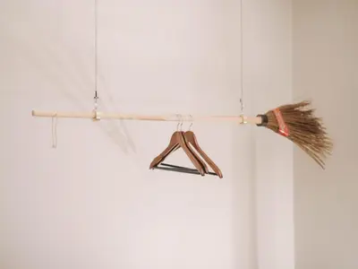 a broom hanging from a stick with a hanger at OPORTO GUEST Harry Potter flat with Parking in Porto