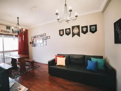 a living room with a black couch and a table at OPORTO GUEST Harry Potter flat with Parking in Porto