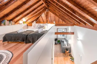 a bedroom with a large bed in a attic at Home in Porto - Cozy 2BR Duplex by LovelyStay in Porto