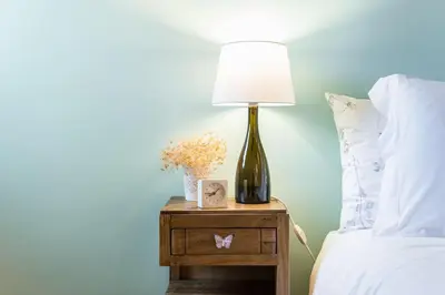 a lamp on a night stand next to a bed at Home in Porto - Cozy 2BR Duplex by LovelyStay in Porto