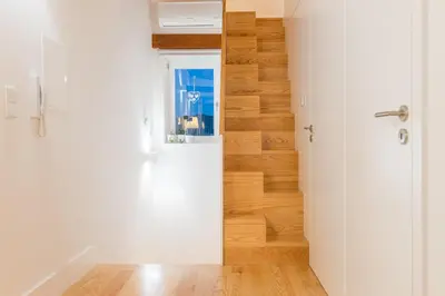 a room with a white door and a wooden floor at Home in Porto - Cozy 2BR Duplex by LovelyStay in Porto