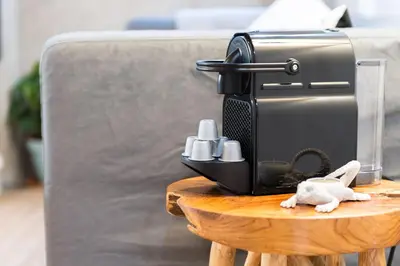 a toaster sitting on a table next to a couch at Home in Porto - Cozy 2BR Duplex by LovelyStay in Porto