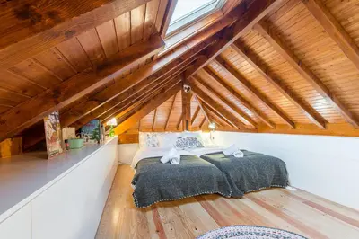 a bedroom with a bed in a attic at Home in Porto - Cozy 2BR Duplex by LovelyStay in Porto