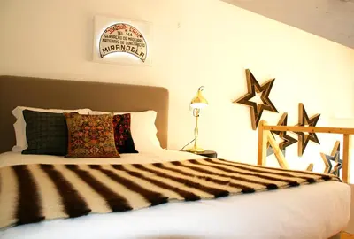 a bedroom with a bed with black and white sheets at Oporto Chic&Cozy - Batalha in Porto