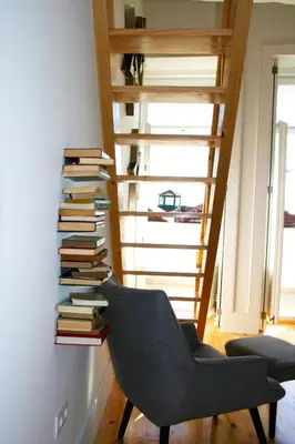 a room with a chair and a stack of books at Oporto Chic&Cozy - Batalha in Porto