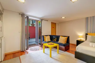 a living room with a couch and a table at Gardenia Urban Retreat in Porto