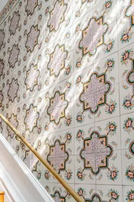 a staircase with christmas decorations on the wall at Gardenia Urban Retreat in Porto