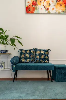 a blue couch in a living room with a painting at Gardenia Urban Retreat in Porto