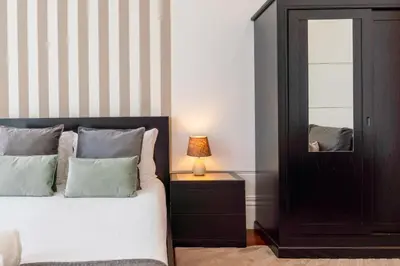 a bedroom with a bed and a mirror at Gardenia Urban Retreat in Porto