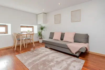 a living room with a couch and a table at Gardenia Urban Retreat in Porto