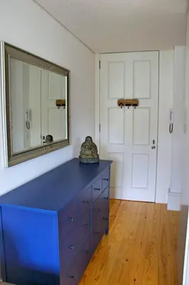 a blue dresser in a room with a mirror at Andorinha Apartment in Porto