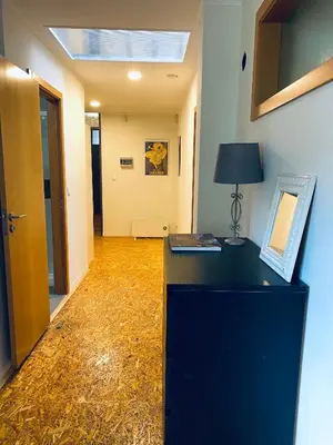 a room with a desk with a lamp and a hallway at Casa Devesas in Vila Nova de Gaia