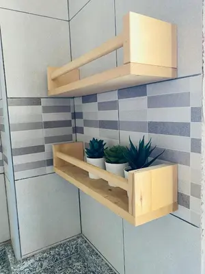 a shelf with three potted plants on a wall at Casa Devesas in Vila Nova de Gaia