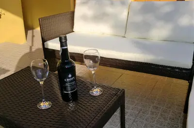 a bottle of wine sitting on a table with two wine glasses at The Yellow House 3 in Porto