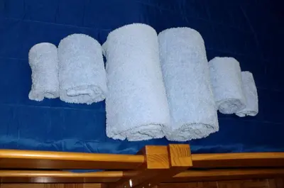 a group of white towels on a blue wall at The Yellow House 3 in Porto