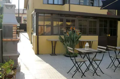 a patio with a table and chairs in front of a building at The Yellow House 3 in Porto