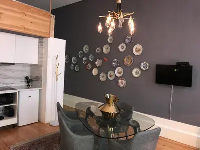 a dining room with a glass table and plates on the wall at Oporto Chic & Cozy - Flores in Porto
