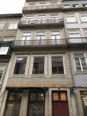 a tall building with windows and a balcony at Oporto Chic & Cozy - Flores in Porto