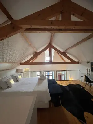 a bedroom with a large bed and a desk at Oporto Golden Apartment in Porto