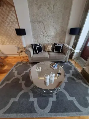 a group of vases with flowers on a table at Oporto Golden Apartment in Porto