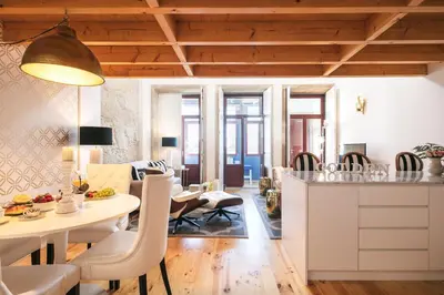 a living room with a table and chairs at Oporto Golden Apartment in Porto
