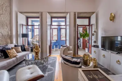 a bedroom with a bed and a desk in a room at Oporto Golden Apartment in Porto