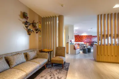 a living room with a couch and a table and chairs at Hotel Spot Family Suites in Porto